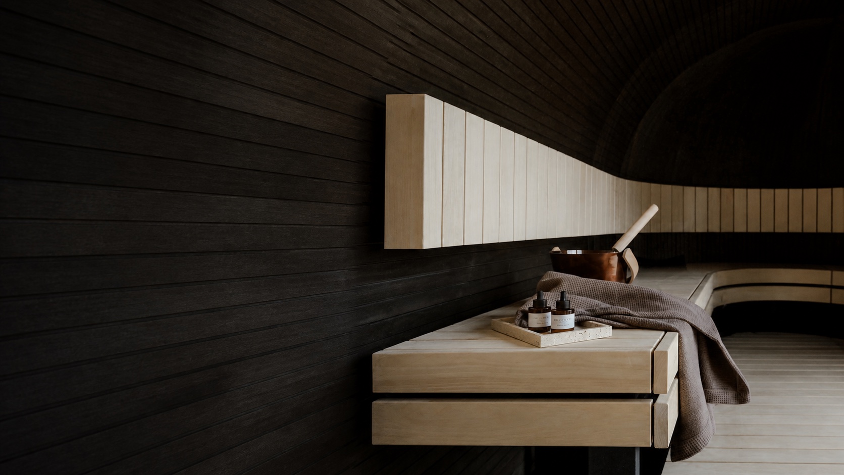 Warm, design-led interior of a Finnish wood-heated sauna